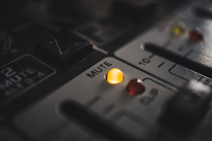 Picture: A mute LED on a modern, digital audio mixer, by Mika Baumeister, license Unsplash